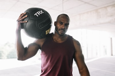 Wearing a red vest, holding a black and white football man
